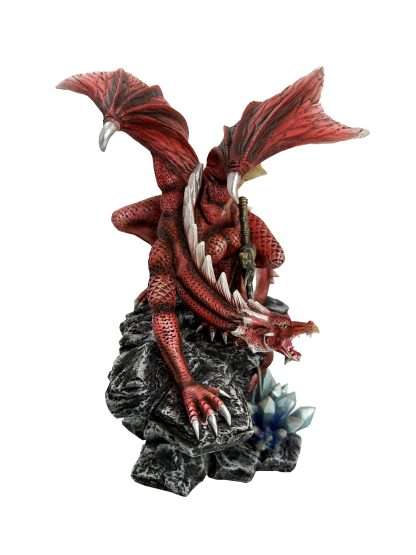 Red dragon figurine on a rocky base with a white background