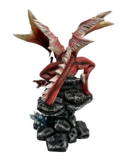 Dragon figurine on rocky base with a white background