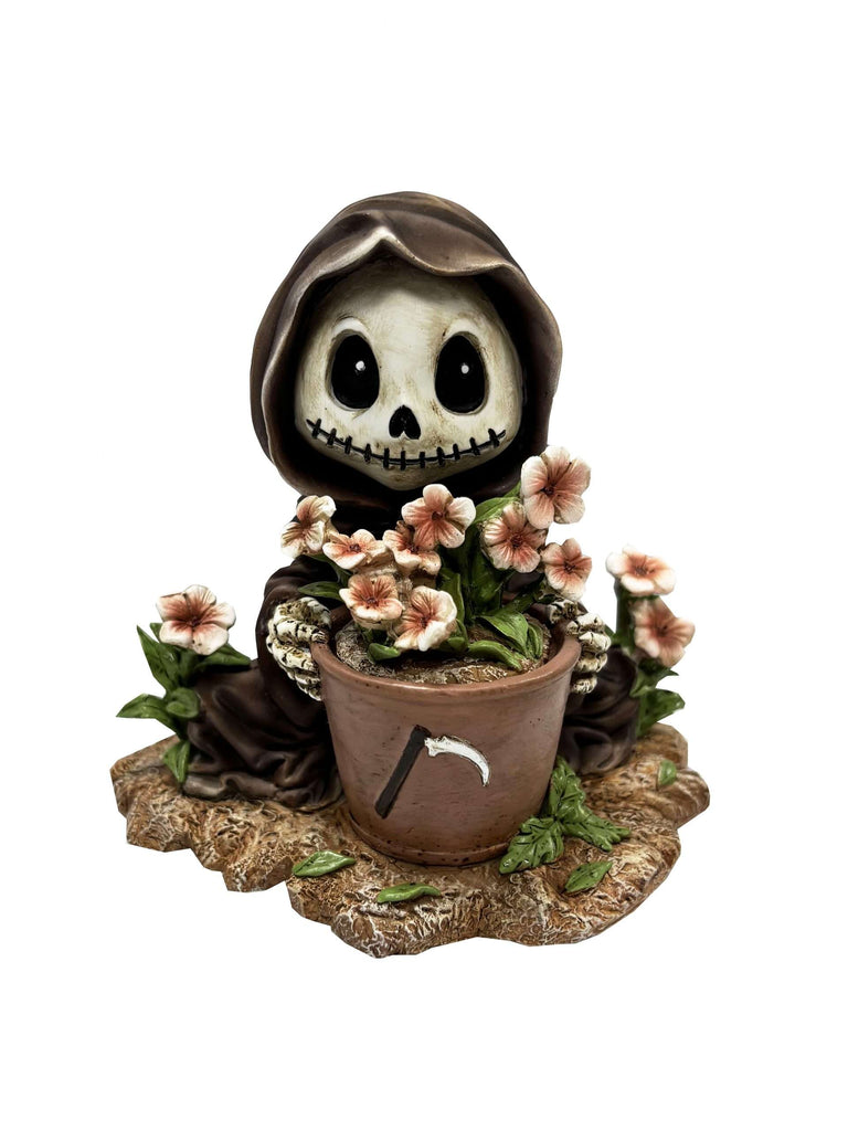 Decorative figurine of a skeleton with flowers and a pot on a white background