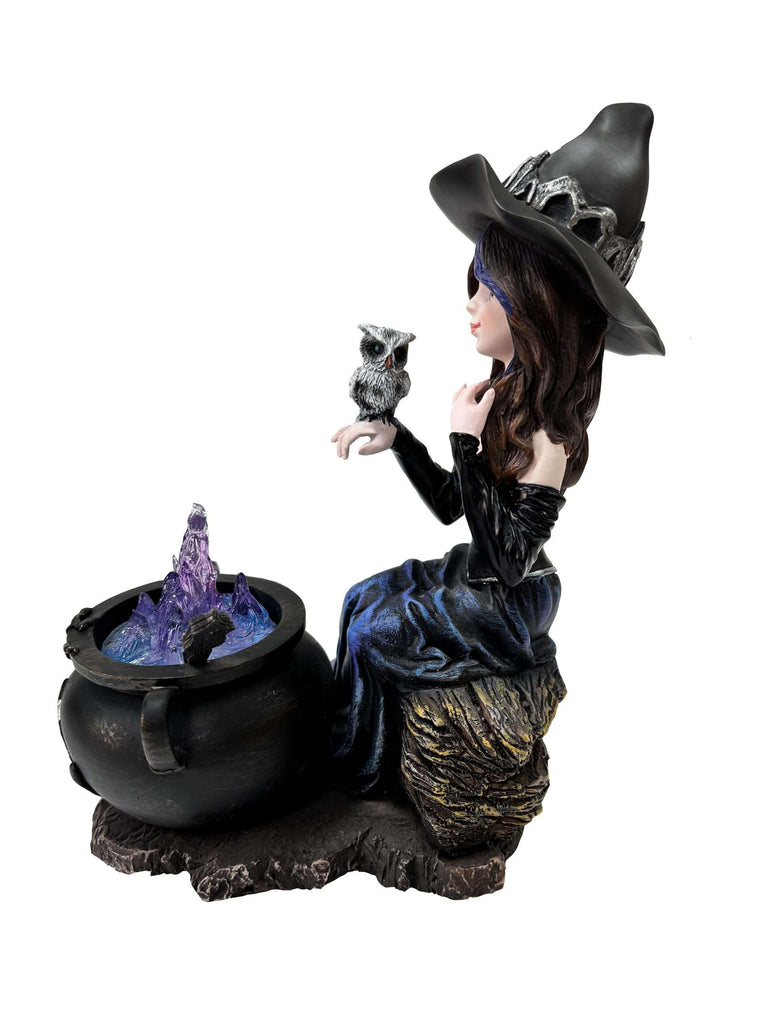 Statue of a witch with an owl and a cauldron on a white background