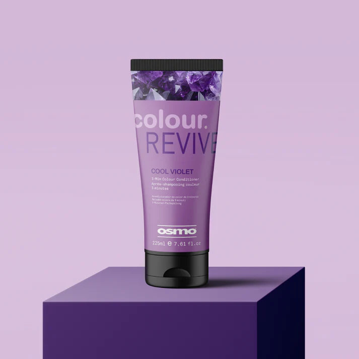 Purple hair color product tube labeled 'colour REVIVE' by Osmo on a purple platform with a purple background.