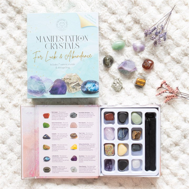 Set of Manifestation Crystals for Luck & Abundance with guidebook on a textured surface
