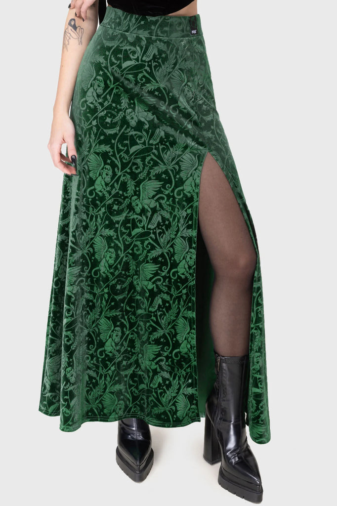 Green patterned skirt with a slit worn by a person on a white background