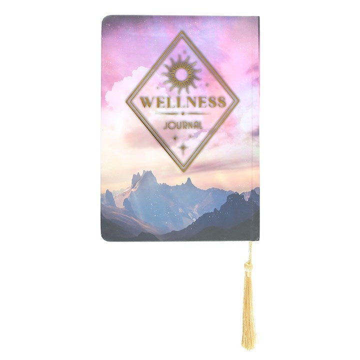 Wellness journal with mountain design and gold tassel on a white background