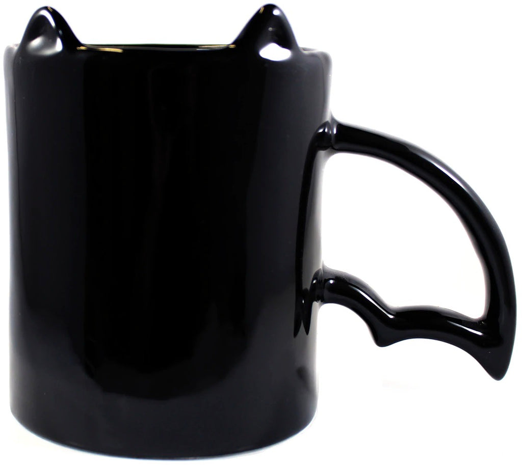 Black mug with cat ears and paw handle on a white background