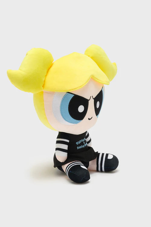 Plush toy with yellow hair and black outfit on a light gray background