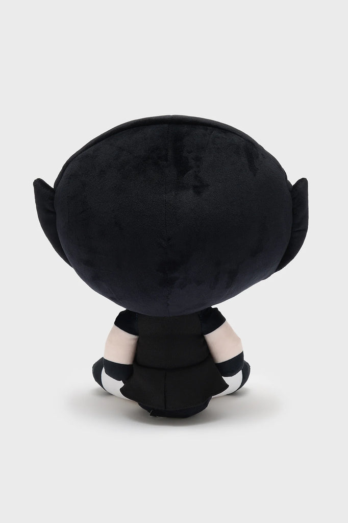 Black plush toy with white accents on a light gray background