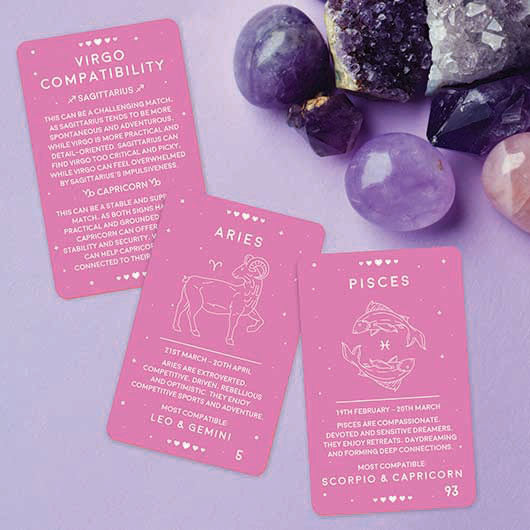 Pink zodiac compatibility cards with crystals on a purple background