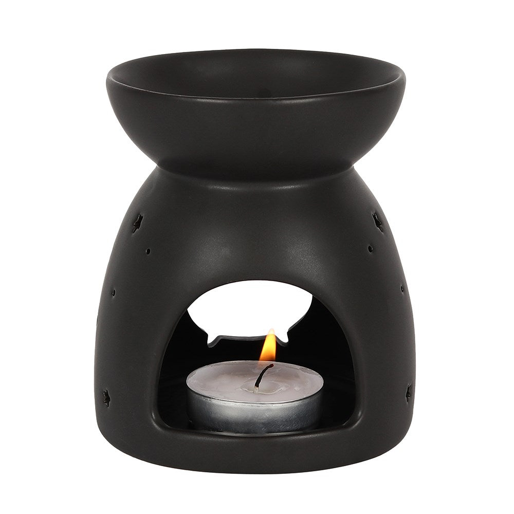 Black ceramic oil burner with a lit tealight candle on a white background