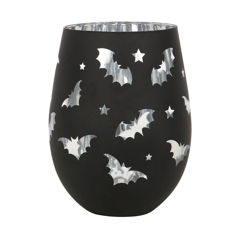 Black wine glass with silver bats and stars pattern on a white background
