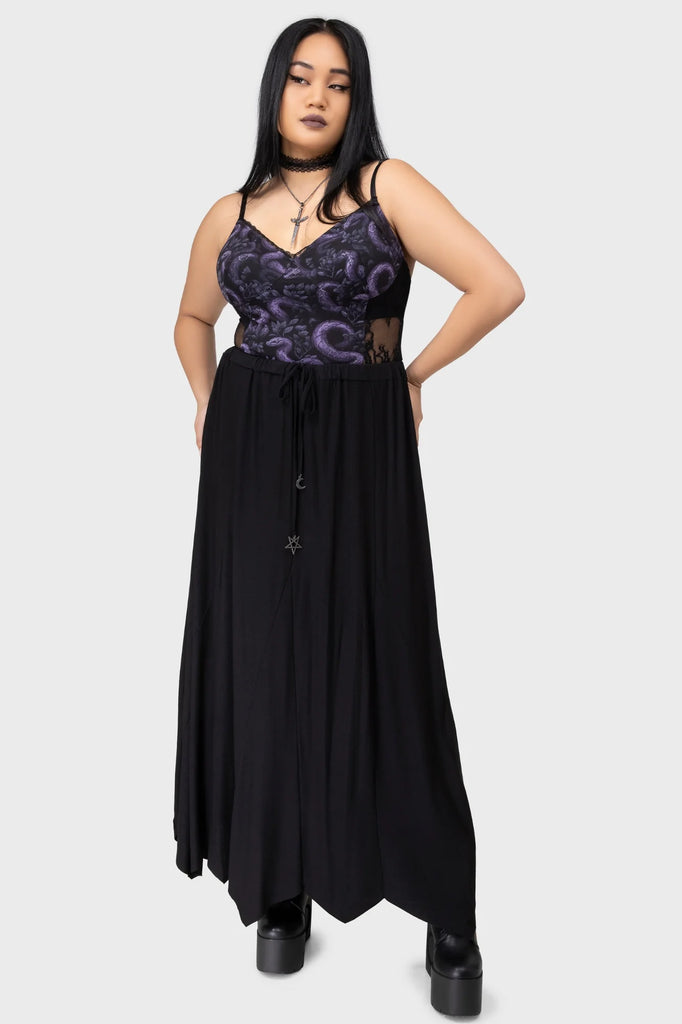 Woman wearing a black and purple dress with a white background