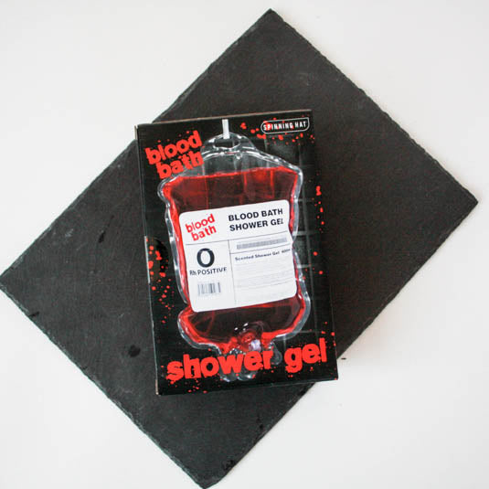 Packaging of 'blood bath' shower gel on a black surface
