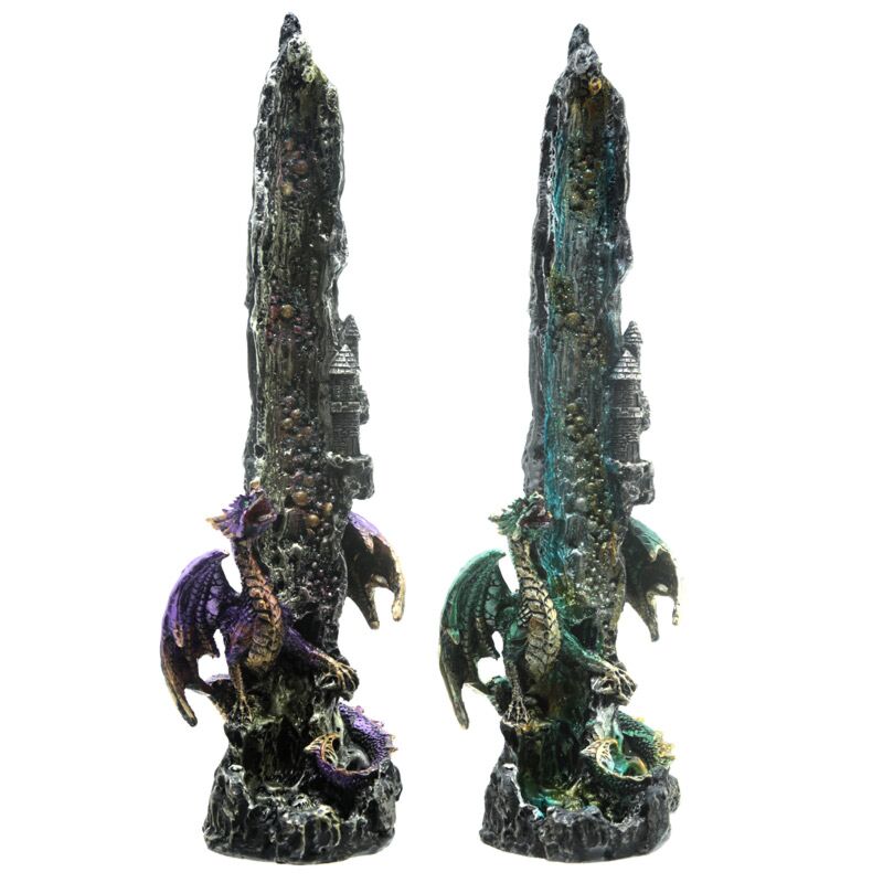 Two dragon figurines on rock-like bases against a white background