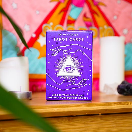 Purple tarot card box with mystical design on a colorful background